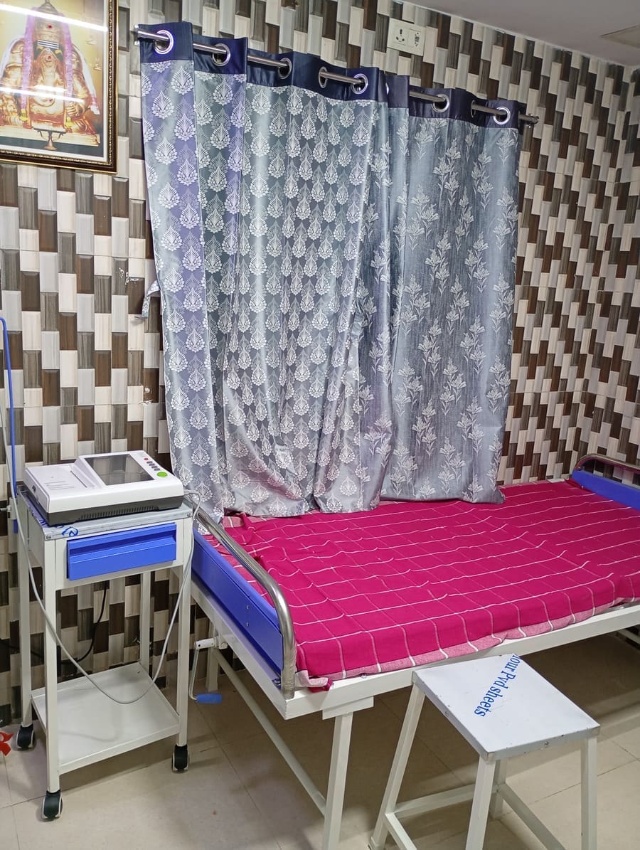 Treatment room with patient bed and medical equipment